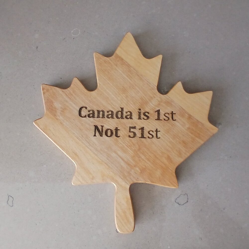 Charcuterie/Cutting Board in the shape of a maple leaf with "Canada is 1st, Not
